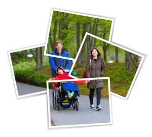 Happy child in wheelchair enjoying the outdoors with his family
